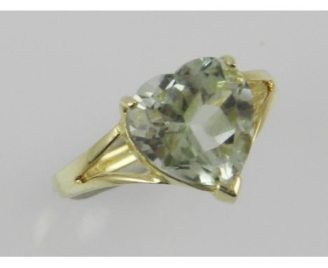 A green amethyst set ring within a 9ct yellow gold band.