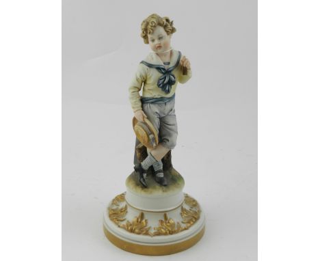 A Capodimonte ceramic figurine of a boy, raised on circular base