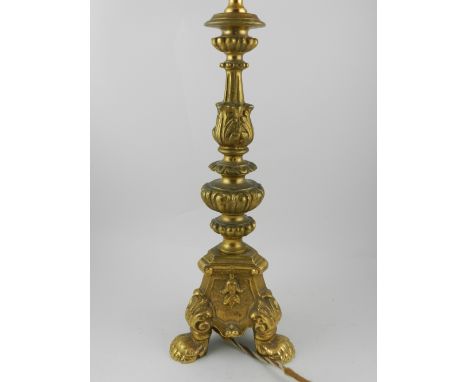 19th century ormolu chased cast lamp, on three lion paw feet.