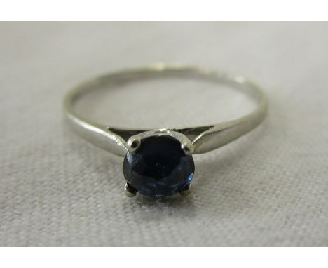 White gold ring set with upturned blue sapphire