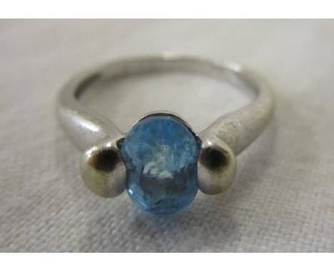 White gold blue topaz set ring