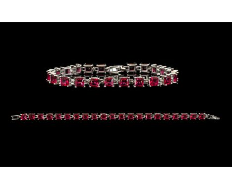 Ruby Tennis Bracelet, 21 Princess cut rubies of rich, glowing red, each measuring just over 1ct, an overall total of 23cts, c