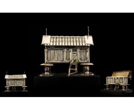 White Metal Trinket Box. Trinket box in the form of a hut supported on a black base, hinged roof, 4 inches high, please see a