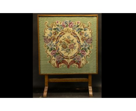 Victorian Tapestry Fire Screen raised on two arched feet, with swivel top.  Tapestry of floral images.  Measures 26" x 19".  