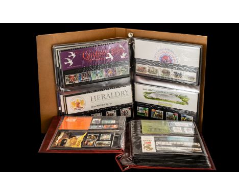 Two Stamp Albums - containing mostly stamps in presentation packs, but also some first day covers. 