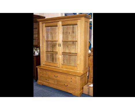 A Large French Oak Contemporary Light Oak Display Cabinet/Bookcase. With 3 adjustable shelves and panelled back with sliding 