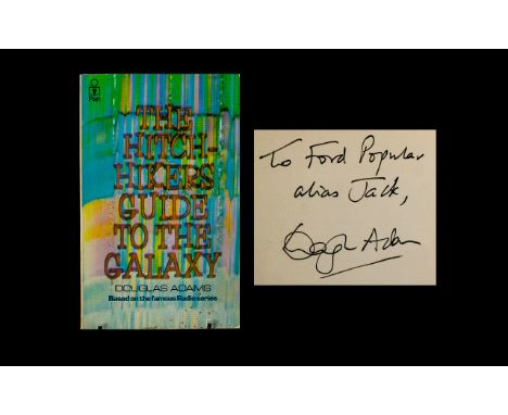 The Hitch Hikers Guide to the Galaxy by Douglas Adams, Pan Books.  The book is signed in ink by Douglas Adams and inscribed t