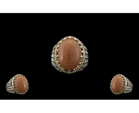 Peach Sunstone Solitaire Statement Ring, a 16ct oval cut cabochon of the sunstone, the soft peach reflecting sparkly inner li