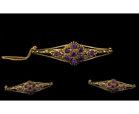 Antique Period Attractive 9ct Gold 'Tiara' - Amethyst Set Hinged Bangle with Attached Safety Chain. The open worked bangle of