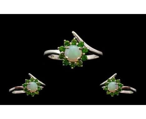 Opal and Russian Diopside Halo Ring, a round cut. natural opal of .75ct framed with .5ct of round cut Russian diopsides, a to