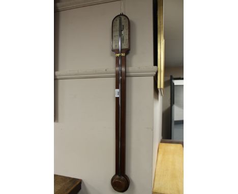 An antique mahogany stick barometer