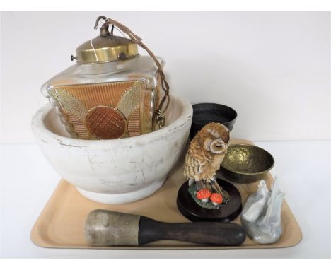 A tray containing a large pestle and mortar, a cast iron mortar, brass embossed bowl, Nao figure and a Russell Willis figure 