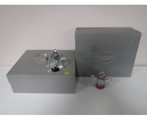 Two boxes containing three glass teapot and three glass coffee pot paperweights 