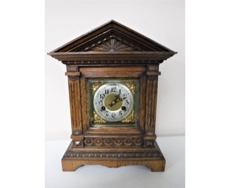 An early twentieth century carved oak cased bracket clock