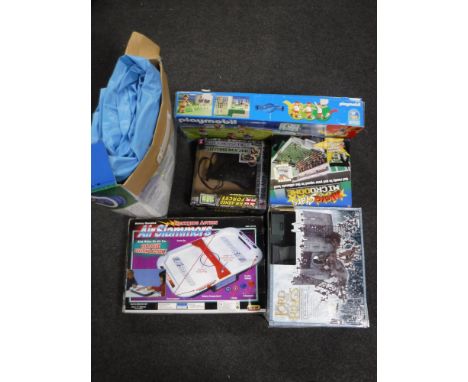 Six boxed toys including Lord of The Rings, Battle at Helms Deep, Playmobil football set, inflatable paddling pool, etc 