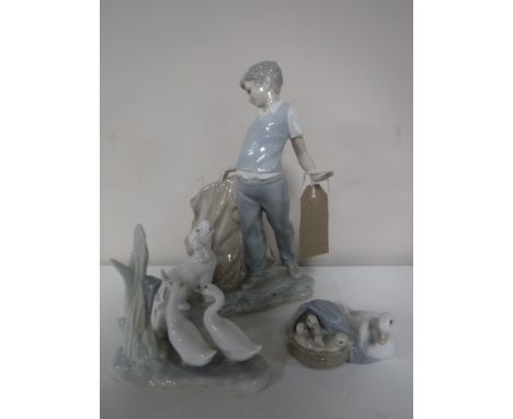 A Lladro figure, duck with chicks, together with a Nao figure of ducks and a Nao figure of a boy with a dog 