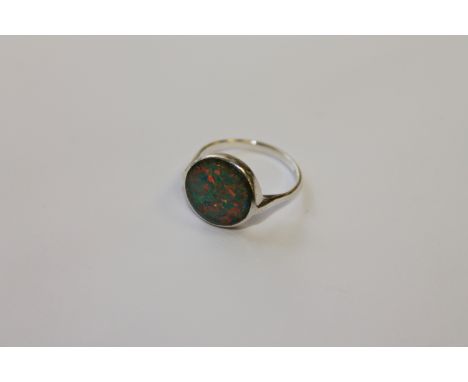 An opal ring set in white metal, size P.