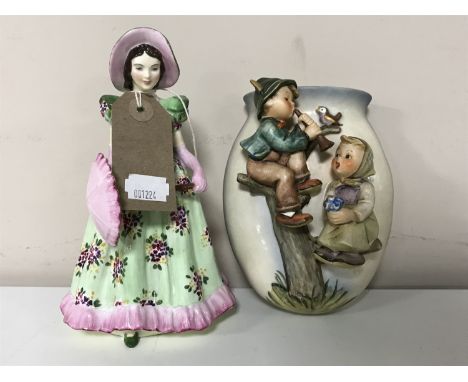 A Radnor china figure, Anne, together with a Goebel china wall pocket 