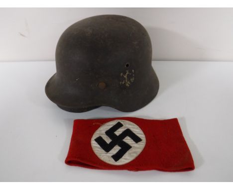 A WWII German army helmet, together with a swastika armband 