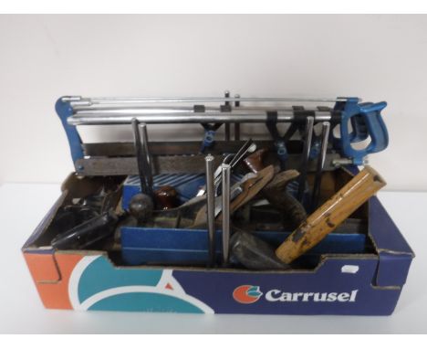 A box containing two Mitre saws, together with assorted Stanley woodworking planes and a sash clamp 