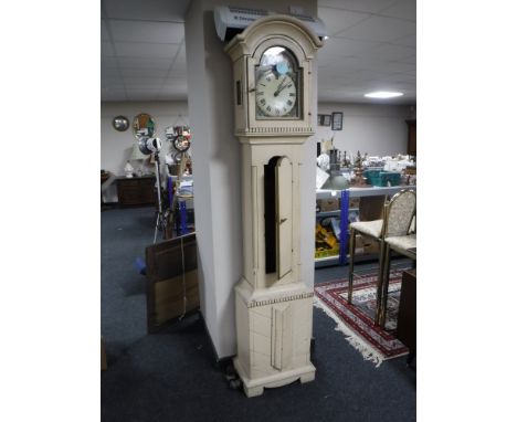 An early twentieth century longcase clock with painted dial, pendulum and weights