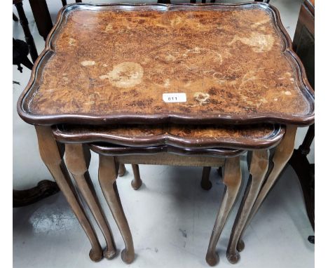 A nest of 3 walnut occasional tables; a reproduction coffee table; a standard lamp 