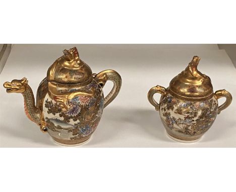 A Japanese Satsuma earthenware dragon teapot , 17cm and a matching sugar basin (lid damaged) small chip to underside of lid o