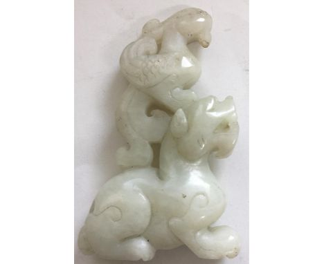 Pale jade coloured hardstone carving of a bird on top of a beast Some loss to beak of mythical bird otherwise OK