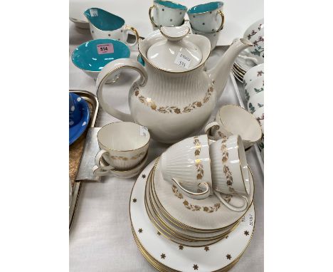A Susie Cooper part tea service gilt stars turquoise interior, 6 cups and saucers, milk jug and bowl and 6 side plates; a par