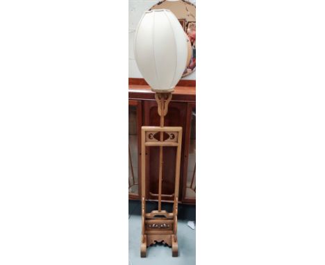 A Chinese natural elm finish lamp standard 
