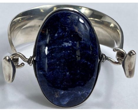 Georg Jensen:&nbsp; a silver bangle designed by Vivianna Torun Bülow-Hübe, the swivel top set oval polished cabochon lapis la