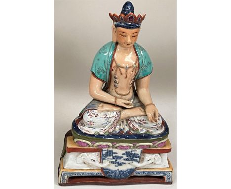 A Chinese ceramic figure of a Buddha in seated lotus position with hole to back possibly for wall hanging, ht. 19cm, good con