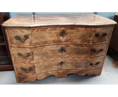 An 18th century South German baroque commode&nbsp; chest of three long drawers, quarter veneered walnut with chestnut banding