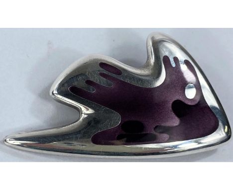 Georg Jensen:&nbsp; a silver brooch in the form of a stylized fish in varying shades of purple enamel, designed by Henning Ko