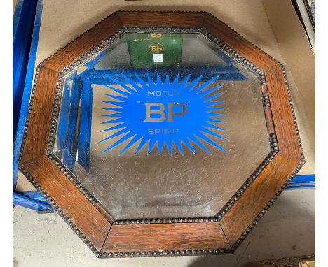 An advertising mirror, 'Motor Spirit' BP, octagonal bevelled edges with oak beaded frame and a vintage BP tin 