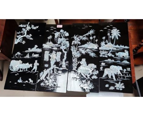 A group of 8 Chinese black lacquer panels with inlaid mother of pearl decoration of genre scenes, 49 x 19cm, in good conditio