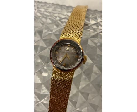 Omega - a late 1950s lady's 18ct gold cased bracelet wristwatch, faceted glass edged crystal, silvered dial, raised gilt bloc