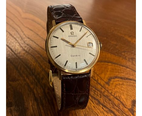 Omega - a 9ct gold cased Geneve 1061 wristwatch, stripped textured dial, block baton markers, date aperture, manual wind cal 