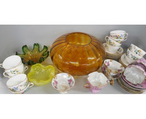 A box of decorative porcelain tea wares including twelve tea cups and saucers decorated with floral motif, other cups with sc