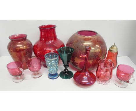 A collection of cranberry, ruby and green glass including two large vases, three cups, jug, wines, etc.
