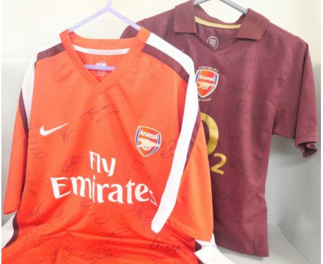 An XL 2009/10 Arsenal shirt signed with 20 players autographs, tags intact. Together with another football shirt, child's 200