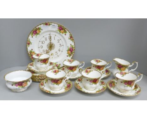 Six Royal Albert Old Country Roses cups, saucers and tea plates, a cream and sugar and a clock