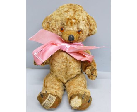 A vintage Merry Thought 'Cheeky Bear' Teddy bear with original bells in ears and label, circa 1958, some a/f, 26cm