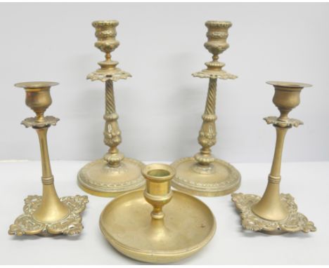 Two pairs of brass decorative candlesticks and one other candlestick 