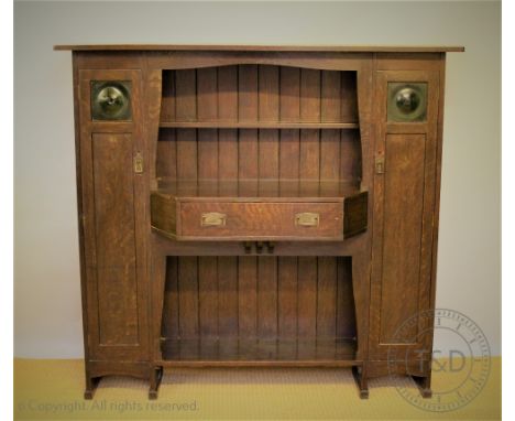 A Leonard Wyburd for Liberty & Co Arts and Crafts oak Hathaway dresser, c1900, with central shelf and drawer flanked by cupbo