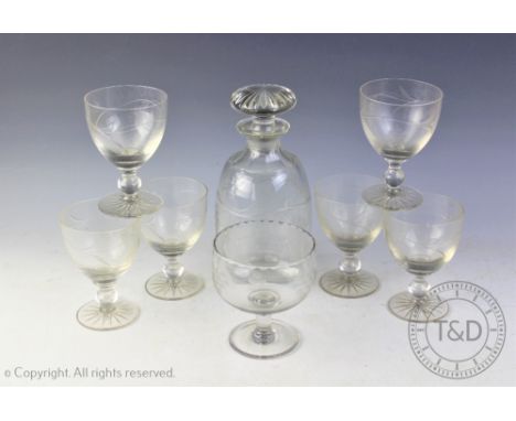 An etched glass decanter set comprising; a decanter and stopper, six glasses and a further large glass, each piece decorated 
