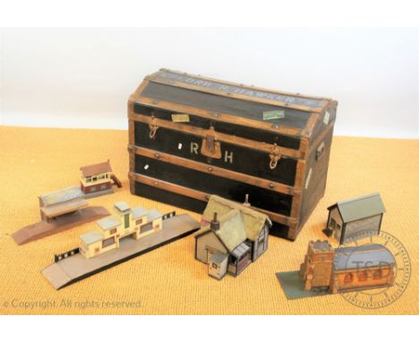A vintage dome top travelling trunk, with later stencilled naming, 56cm H x 84cm W, enclosing home made railway buildings (6)