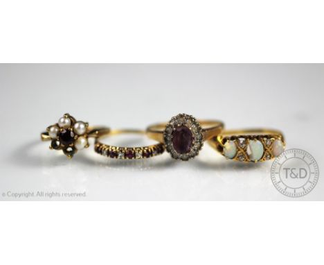 A ruby and diamond half eternity ring set in 9ct yellow gold, and three further rings to include amethyst, garnet and opal, e