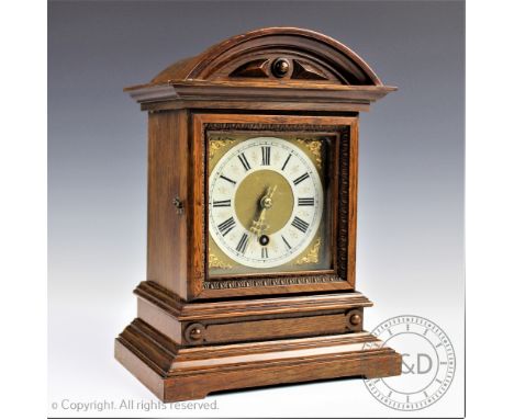 An Edwardian carved oak eight day mantel clock, with Roman numeral card chapter ring and movement striking on a gong, 28.5cm 