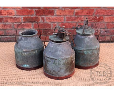 Three vintage copper milk churns, two with unit tops
